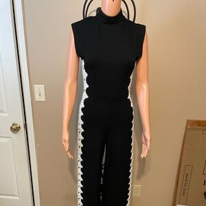 Bebe Elegant Black Jumpsuit with White Lace Trim zipper in back,
